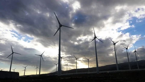 Wide shot of wind generators in arinaga at sunset with beautifull clouds Stock Footage 97463350