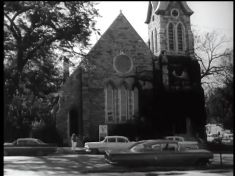 Wide shot of woman walking into church, 1960s Stock Footage 61766796