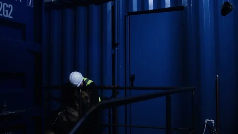 Wide shot as worker is caught sleeping on the job on nightshift at a Video stock 128796289