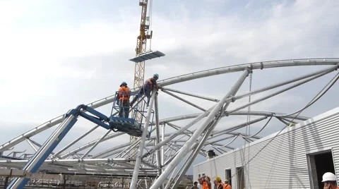 Wide shot of workers constructing metal beam roof Stock Footage 46139561