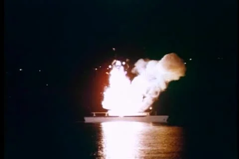 Wide shot of yacht exploding at night in port Stock Footage 11365735