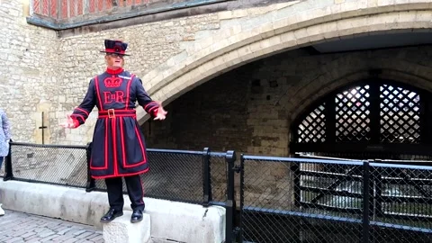 Wide shot of Yeoman Warder explaining Traitors' Gate under St Thomas's Stock Footage 237230127