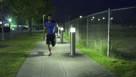 Wide shot of young man running at night Video stock 76236652