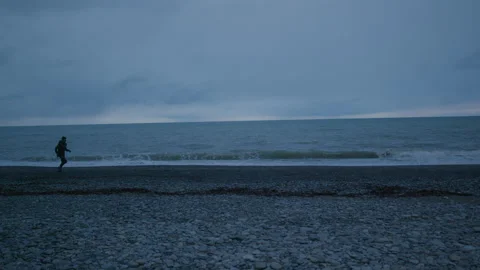 Wide shot of Young runner. Training at nasty weather Stock Footage 147923201