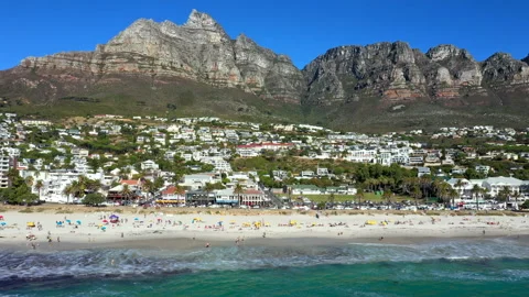 Wide side tracking shot showcasing the entire length of Camps Bay beach Stock Footage 170726395