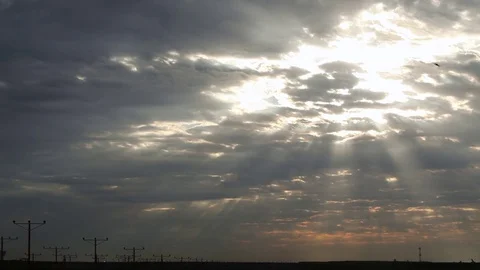 Wide of a silhouetted airplane taking off in front of a sunrise cloudscape Stock Footage 80439864