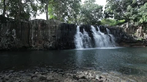 Wide Slow pan right of waterfall in Mauritius Stock Footage