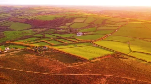 Wide Slowly Rotating Aerial View Over English Countryside with Sprawling Farmed Stock Footage 325853850