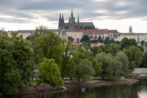 A wide spring landscape view shows Prague Castle and St. Vitus Cathedral do.. Stock Photos