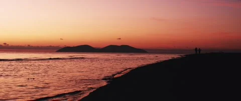Wide static anamorphic shot of sunset over the sea Stock Footage 324460356