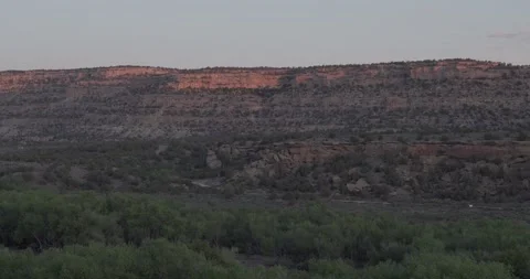 Wide static establishing shot layering cottonwood forest in the lower frame,  Stock Footage 334873084