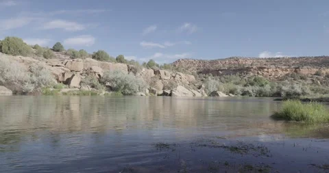 Wide static landscape shot of the San Juan River with large boulders in the f Stock Footage 336637361