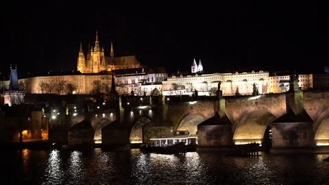 Wide static night clip of Charles Bridge and Prague Castle at dusk. The bridge Video stock 103609553