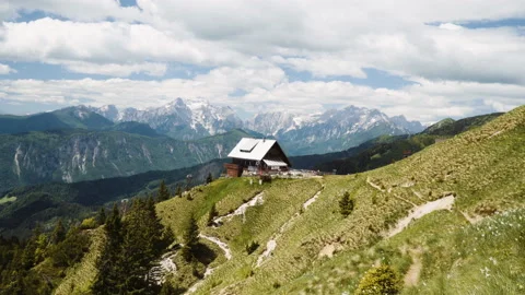 Wide static shot, alpine cottage in Europe Alps mountains. Stock Footage 132250762