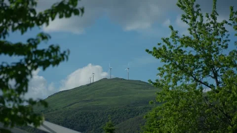 Wide static shot of row of windmills on the top of the mountain generating Video stock 338126945