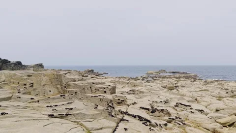 Wide static shot of the rugged granite coastline at the Cote de lIle Grande in Stock Footage 346696224