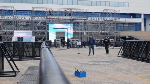 Wide Static shot of the technical preparation of the stage of an outdoor event Stock Footage 123369689