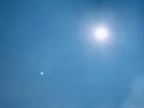 Wide Static View of Bright Sun in Blue Jakarta Sky Stock Photos