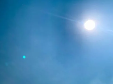Wide Static View of Bright Sun in Blue Jakarta Sky Stock Photos