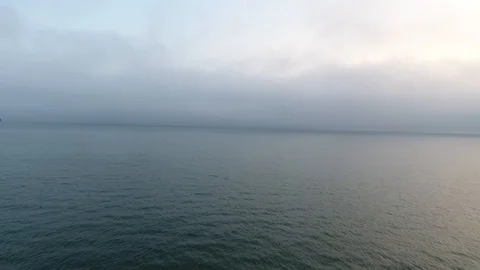 Wide still evening shot speeding across the calm waters of the Pacific Ocean Stock Footage 104061271