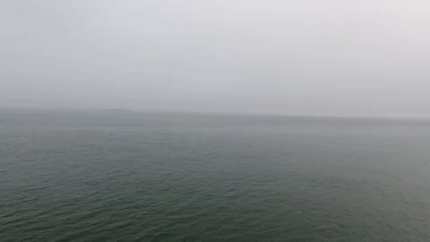 Wide still evening shot speeding across the calm waters of the Pacific Ocean 库存影片 104069003