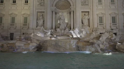 Wide still shot of the empty Trevi Fountain, woman walks into the shot. Stock Footage 266856106