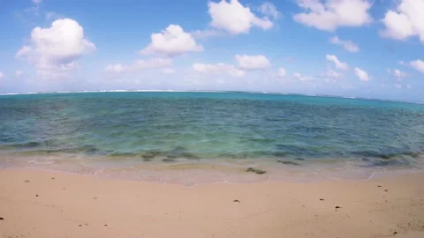 Wide still slow moving down view of turquoise color lagoon Stock Footage 157791392