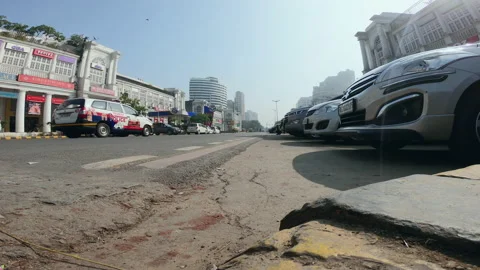 Wide, street level view, low traffic on a sunny day, New Delhi, India Stock Footage 140544550