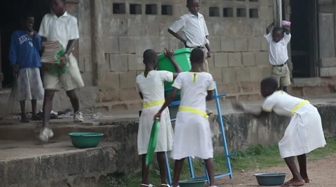 WIDE: STUDENTS CLEANING OUT AND AROUND A HANDWASHING STATION Stock Footage 60525087