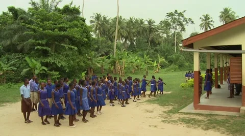 WIDE: STUDENTS MARCHING TO CLASSROOMS FROM SCHOOL MORNING ASSEMBLY Stock Footage 60116262