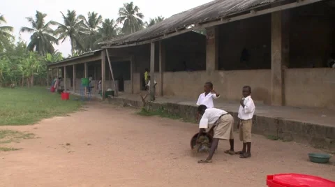 WIDE ON STUDENTS SWEEPING AND CLEANING SCHOOLYARD Stock Footage 60627691