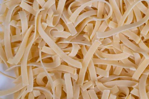 Wide texture egg noodles background image with dense ribbon pattern, neutral  Stock Photos