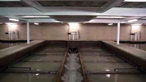 WIDE TILT DOWN TO MAIN WATER FILTERING IN LAKE FILTRATION PLANT Stock Footage 106139845