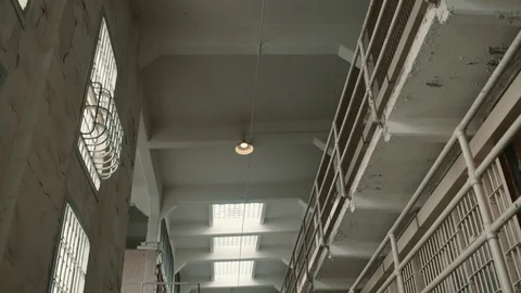 Wide tilt down shot of main corridor with prison cells on Alcatraz Island, Stock Footage