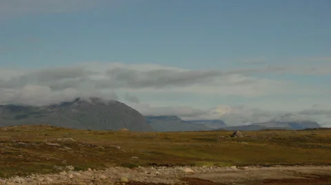 Wide time-lapse of clouds over a rocky landscape in Greenland Stock Footage 30311357