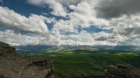 Wide time lapse shot of clouds and their shadows over mountain landscape Vídeos de archivo 192981881