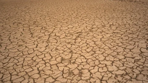 Wide Top-Down Tracking Shot of Vast Cracked Parched Earth in Climate Crisis Stock Footage 334711602