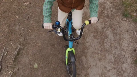 Wide top view of boy riding bicycle training outdoors Stock Footage 316581909