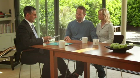 Wide, Track shot off couple signing contract at dinning table and handshake s Stock Footage