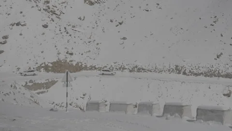 Wide Tracking Shot of Car Driving in Snow-Covered Roads in Ladakh- 28th Feb 2025 Stock Footage 313259306