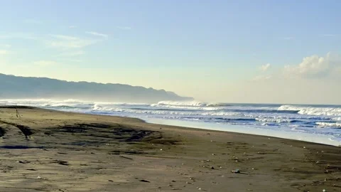 Wide tropical beach with distant headland and waves Video stock 335430681