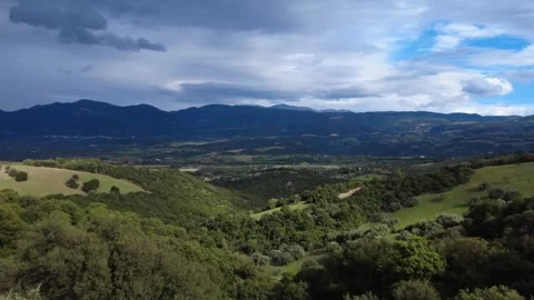 Wide valley view with mountains and cultivated plains Stock Footage 343993676