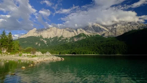 Wide video of Eibsee lake shore and Zugspitze mountain peaks in Bavaria Germany Stock Footage 346165543