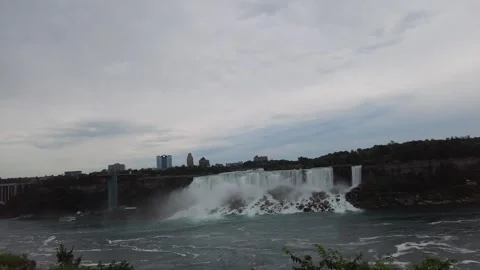 Wide view across the Niagara River to the American Falls and Rainbow Bridge Stock Footage 345996047