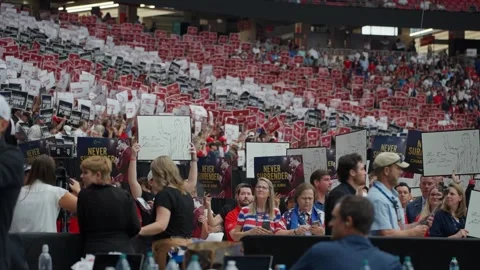 Wide view of attendees holding signs at the Charlie Kirk memorial service Stock Footage 345298091