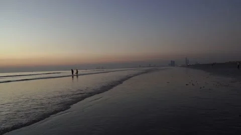 Wide view of beach waves during sunset in Karachi with birds, 4k Stock Footage 146864040