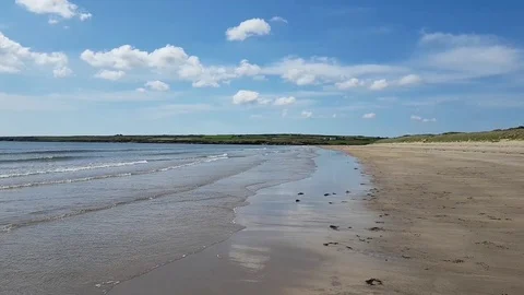 A wide view of a beautiful empty beach on a summer day at Aberffraw Wales Stock Footage 122431665