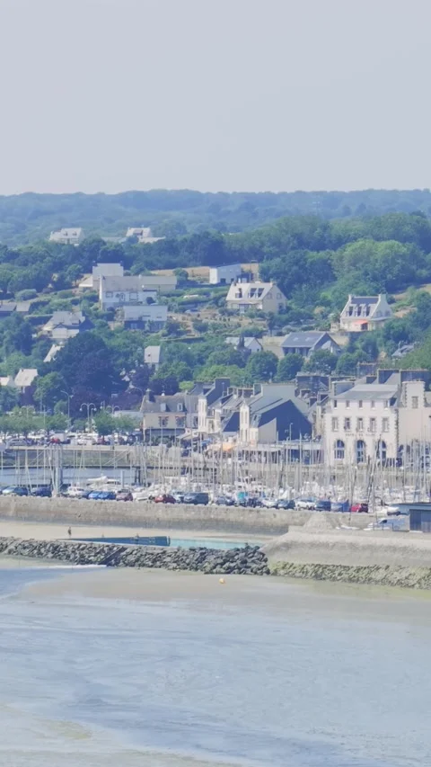 Wide view of Binic beach and town in Brittany, France, showing a marina filled Stock Footage 346663391