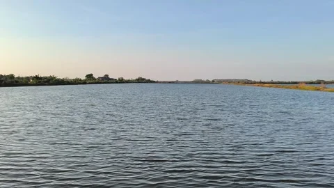 Wide View of Calm Fish Pond and Clear Sky in Rural Landscape Stock Footage 340489202
