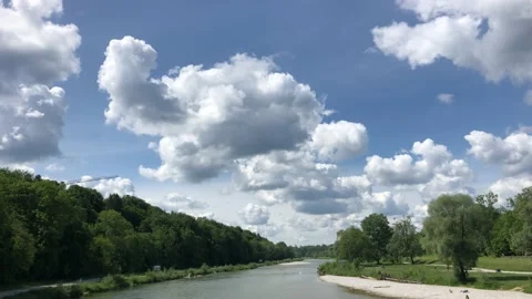Wide view of calm Isar river with clouds on a sunny day Stock Footage 132659657